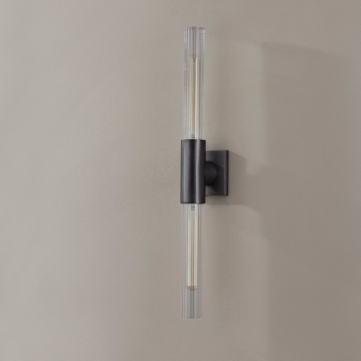 Close-up of the Asher Wall Sconce 4.25" in bronze showing the arm curve and shade silhouette.