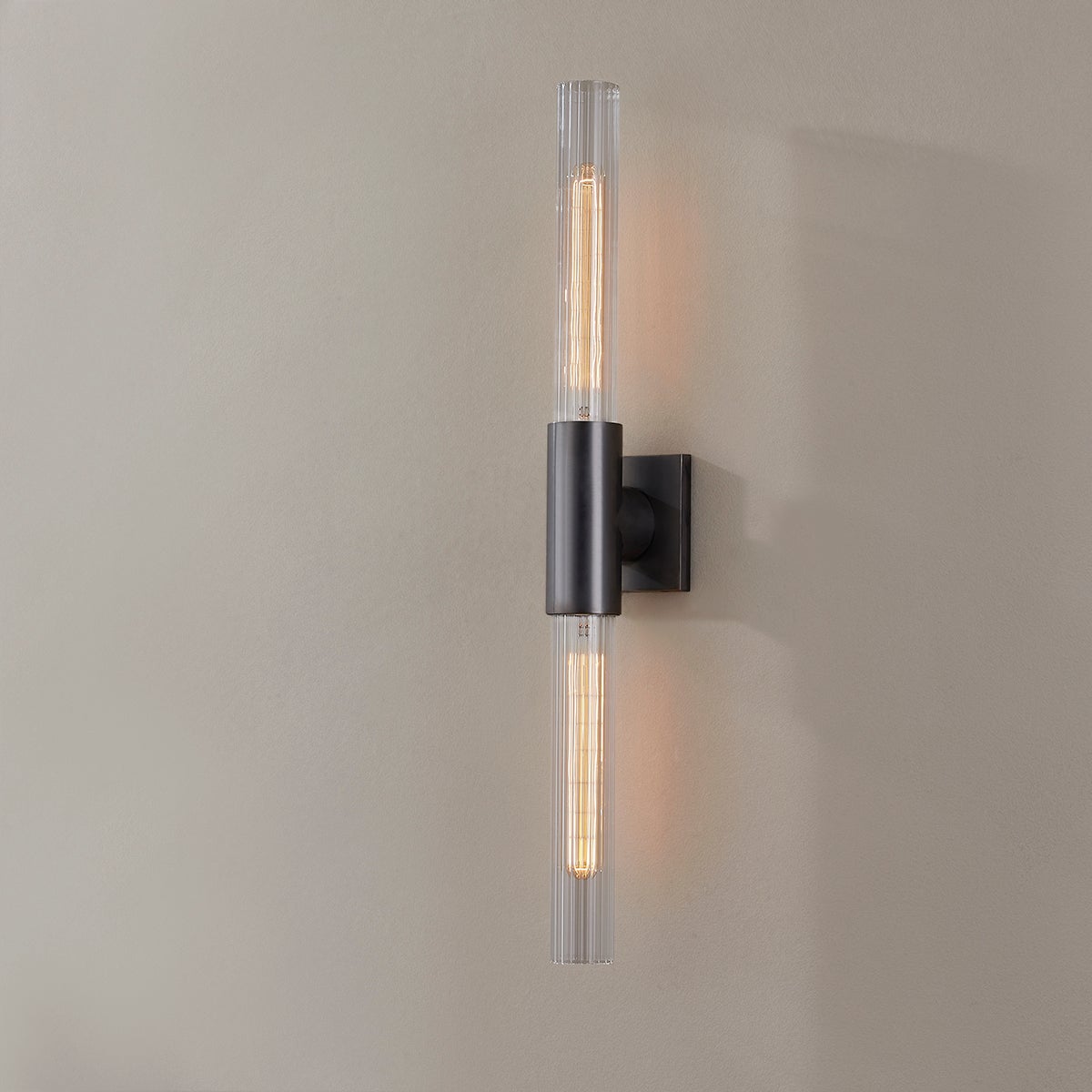 Close-up of the Asher Wall Sconce 4.25" in bronze showing the arm curve and shade silhouette.