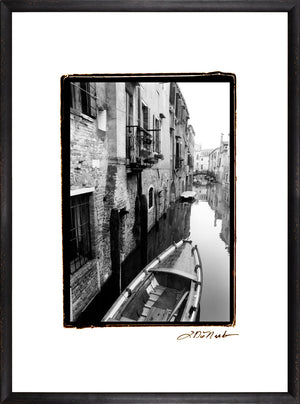 Waterways Of Venice V wall art featuring a black and white canal scene with a boat.