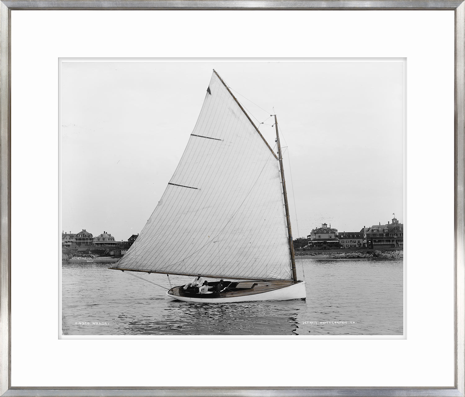 Wanda wall art featuring a black and white photograph of a sailboat on water.