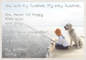 My Sunshine wall art featuring handwritten lyrics on a serene background with a child and dog fishing.