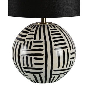 Milka table lamp featuring a round ceramic base with bold black patterns and a tapered black linen shade.