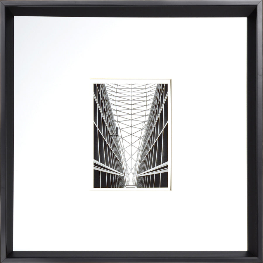 Architecture wall art featuring a black and white geometric design of a building interior.