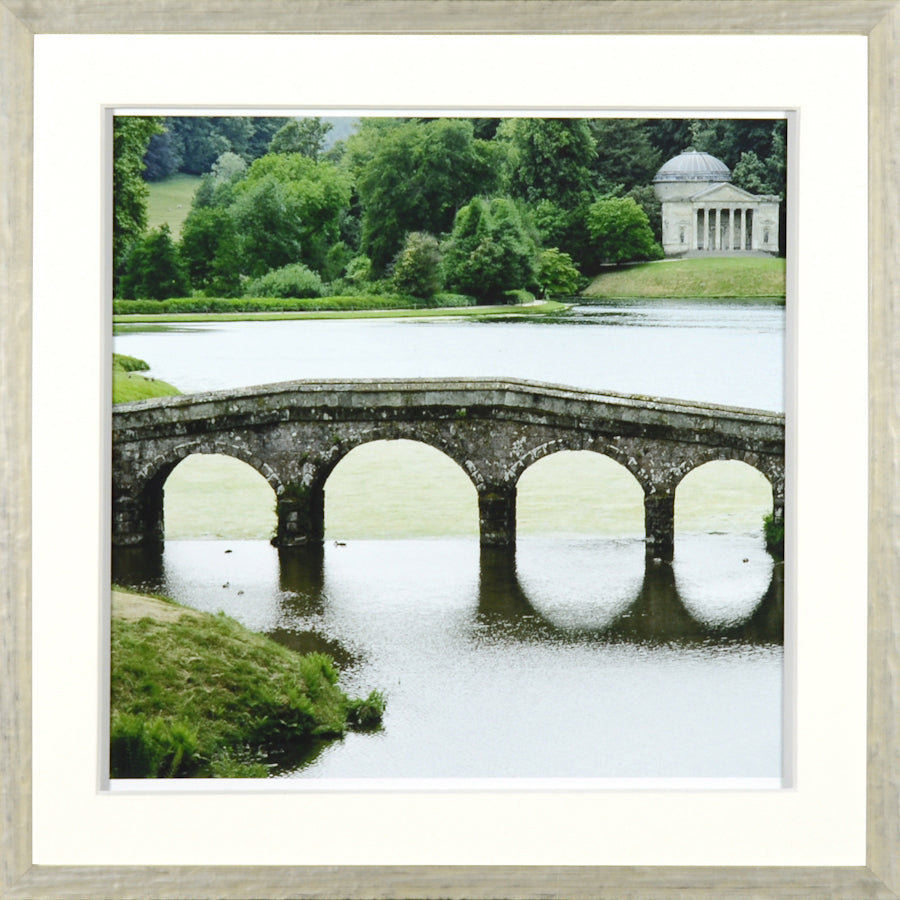 Jardin Vert Formel VI wall art featuring a stone bridge over a serene lake with lush greenery.