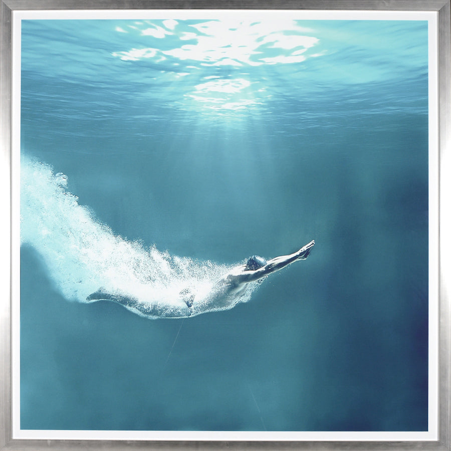 Into The Deep wall art featuring a swimmer diving underwater with light rays filtering through