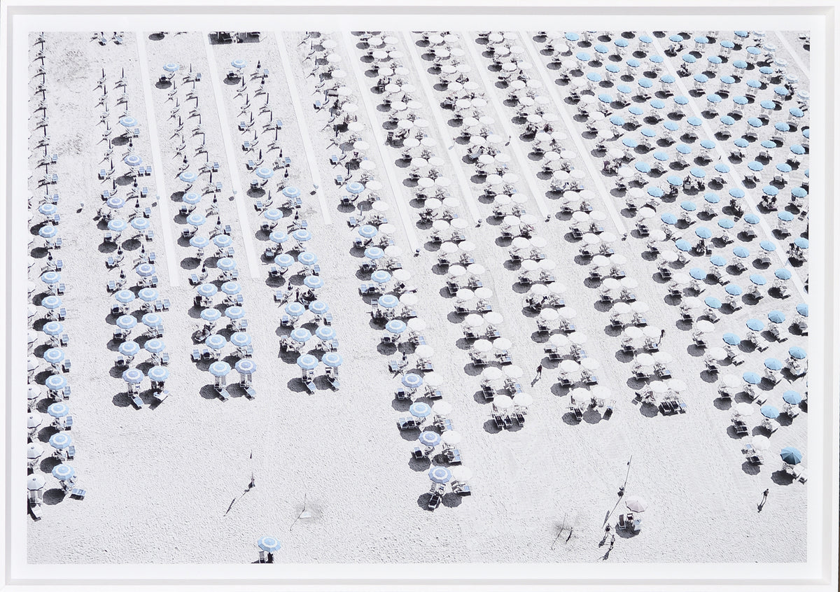 Aerial Beach View #1 wall art featuring rows of blue and white umbrellas on a sandy beach.