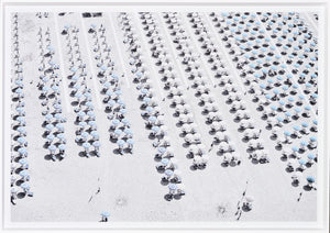 Aerial Beach View #1 wall art featuring rows of blue and white umbrellas on a sandy beach.