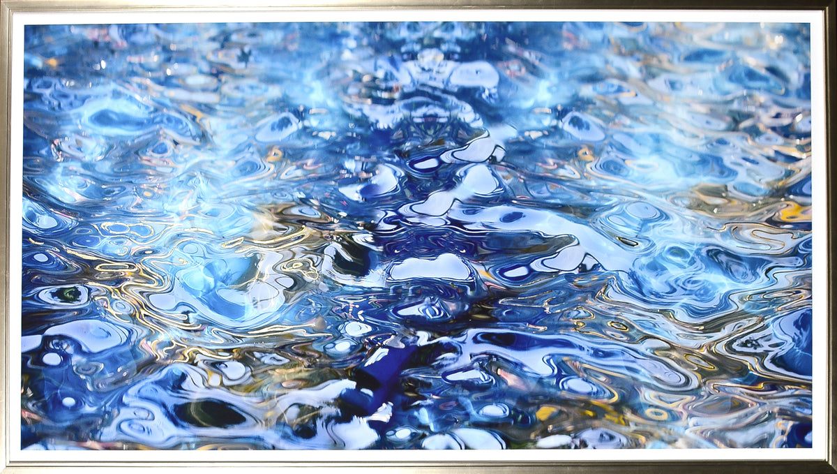 Gilded Ripples wall art featuring abstract blue water reflections with shimmering highlights
