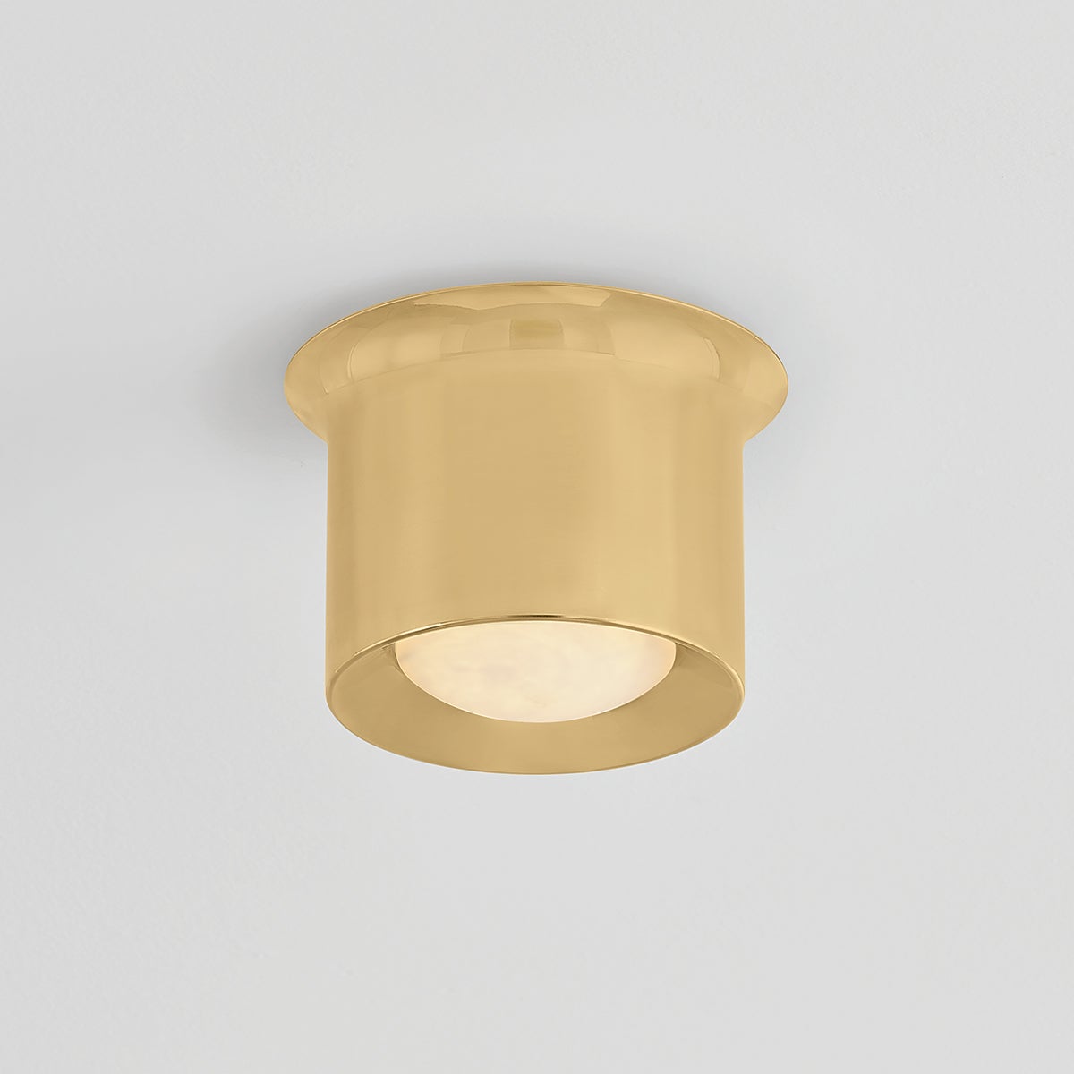 Close-up of the Noxon Flush Mount 7" in aged brass showing the shade profile and mounting canopy.