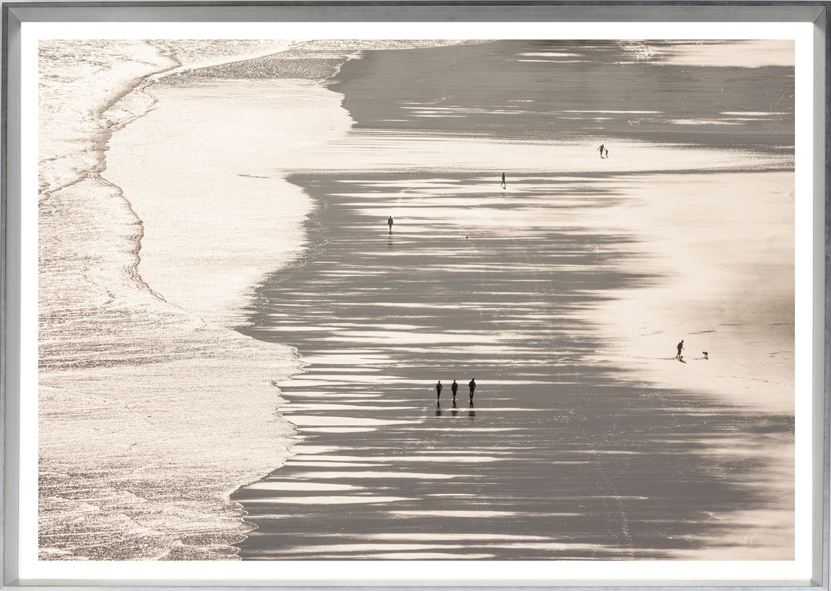 Mirrored Beach wall art featuring a serene beach scene with silhouetted figures walking on wet sand.
