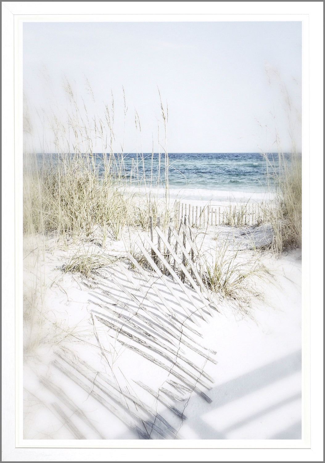 Dune Vista II wall art featuring a serene beach scene with sand, grass, and ocean waves, framed in white.