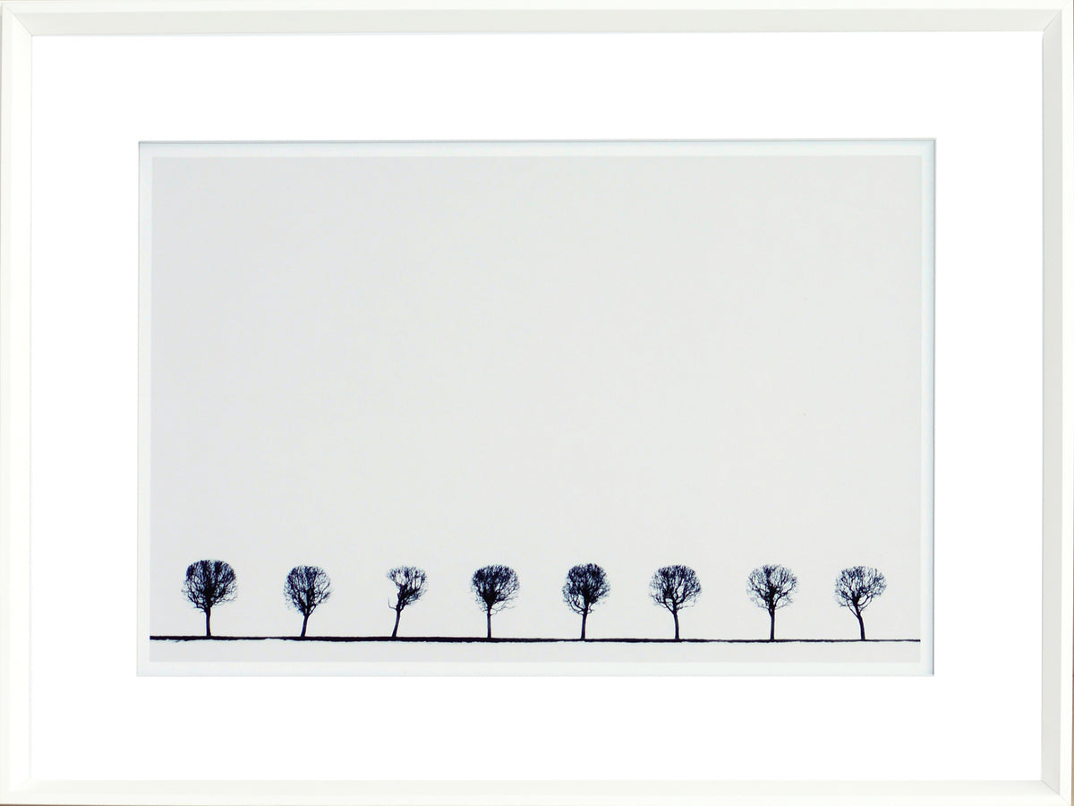 Indigo Landscape Series V wall art featuring a row of silhouetted trees against a white background.