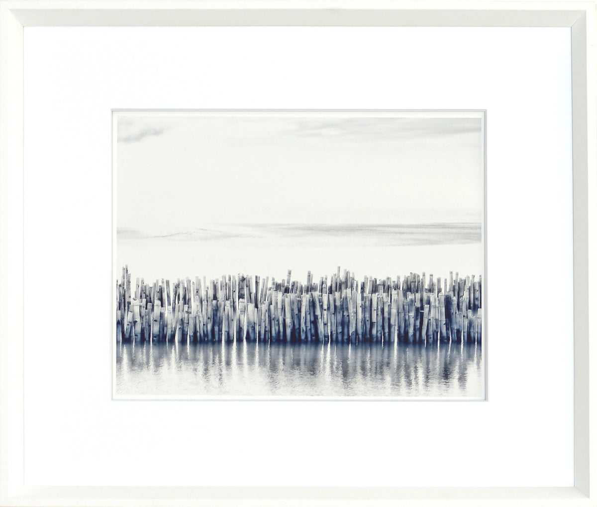Indigo Landscape Series VII wall art featuring a serene water scene with wooden posts in shades of blue and gray.