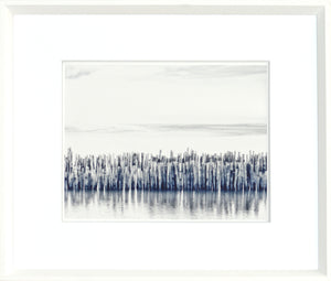 Indigo Landscape Series VII wall art featuring a serene water scene with wooden posts in shades of blue and gray.