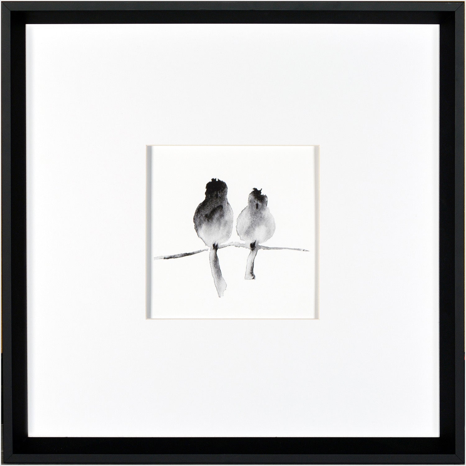 A Pair wall art featuring two birds in black watercolor on a white background, framed in black.
