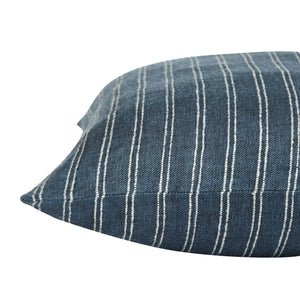 Oakley pillow featuring a blue fabric with white vertical stripes, angled view showcasing its texture and design.