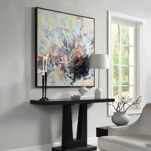 Iman wall art featuring an abstract design with soft pastel colors and bold black accents, framed in black.