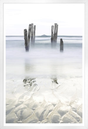 Breakwater wall art featuring weathered wooden posts in calm water, soft gray and white tones.