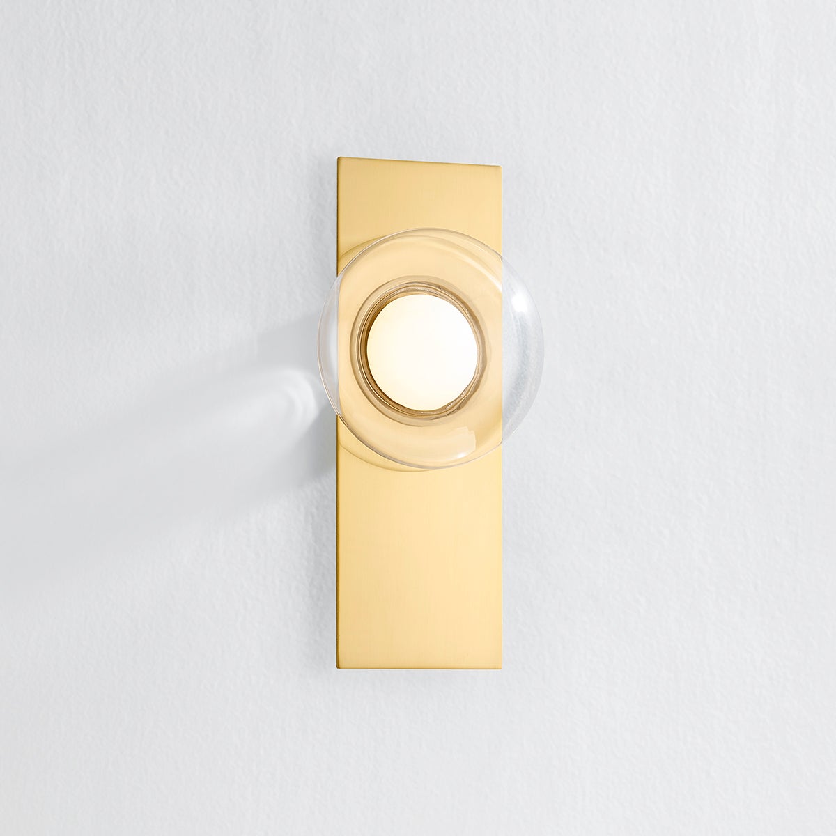 Close-up of the Pound Ridge Wall Sconce in aged brass showing the arm curve and shade silhouette.
