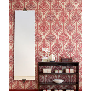 Ashlar mirror mounted on a patterned red wallpaper, complementing a stylish interior setting.