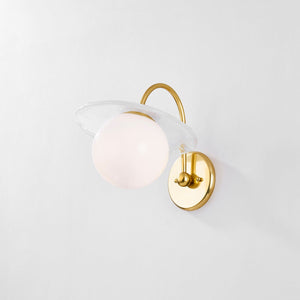 Close-up of the Stampford Wall Sconce in aged brass showing the arm curve and shade silhouette.