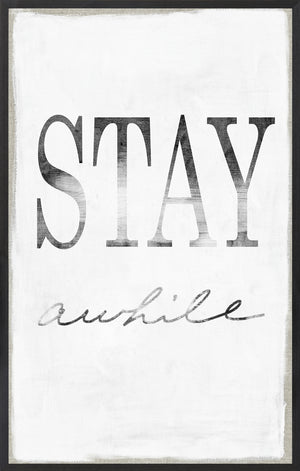 Stay Awhile wall art featuring bold black text on a white background with a gray frame.