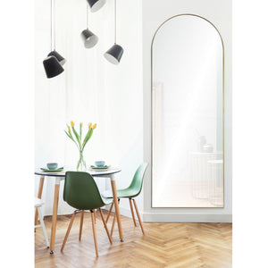 Thatcher mirror with an arched gold frame, reflecting a bright dining area with green chairs and a vase of tulips.