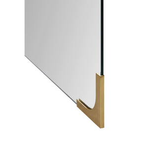 Eros mirror with a clear surface and polished brass base corner detail.