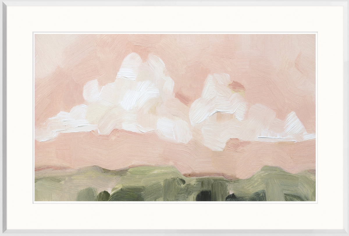 Pink Haze Sunset I wall art featuring soft pink clouds and green hills, framed in white.