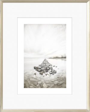 Taupe Aspect V wall art featuring a serene landscape with rocks extending into water.