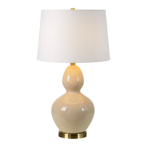 Jesula Table Lamp - illuminated beige ceramic base with white shade, showcasing a warm glow