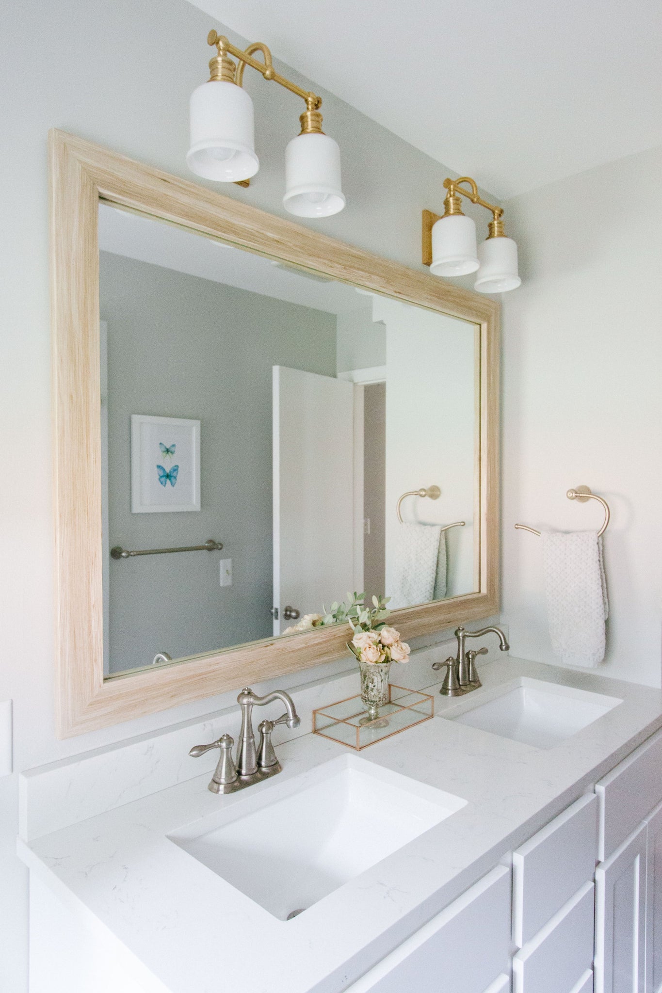 Close-up of the Keswick Bath And Vanity 13.5" in aged brass showing the arm spread and shade silhouette.