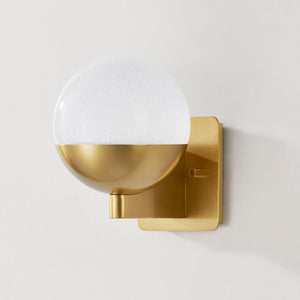 Close-up of the Rochford Wall Sconce in aged brass showing the arm curve and shade silhouette.