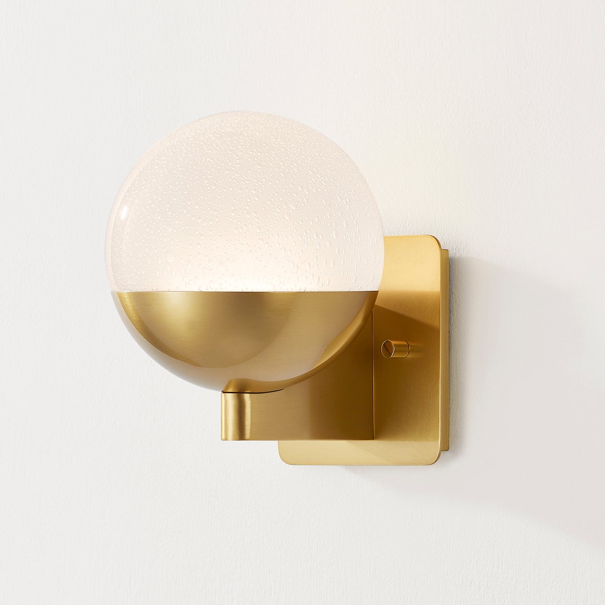 Close-up of the Rochford Wall Sconce in aged brass showing the arm curve and shade silhouette.