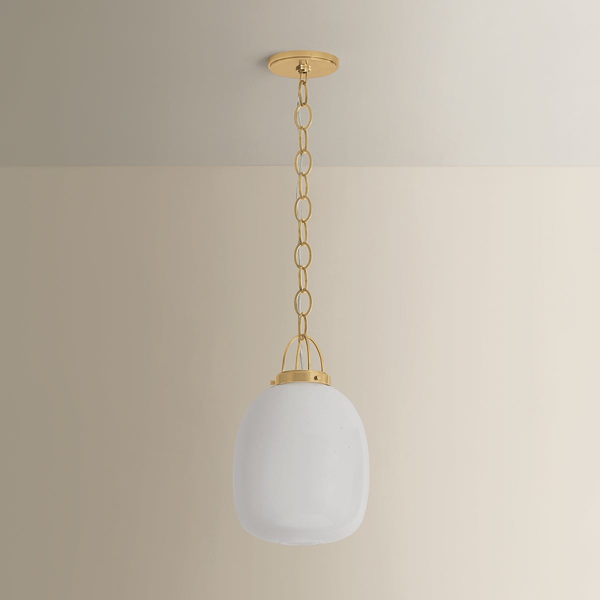 Enosburg Pendant 11" in aged brass shown from the front to reveal the shade shape and metal detail.