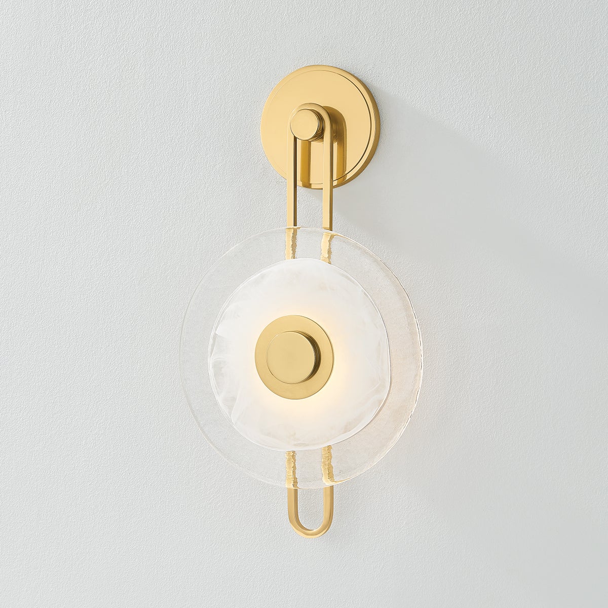 Close-up of the Keuka Park Wall Sconce in aged brass showing the arm curve and shade silhouette.