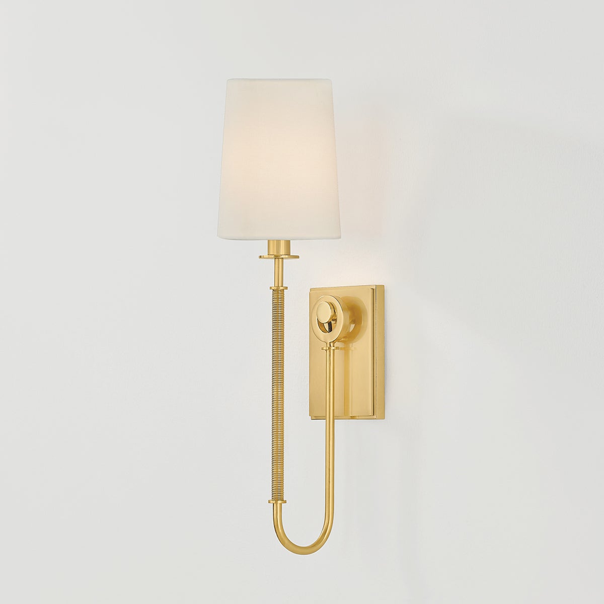 Close-up of the Glenmont Wall Sconce 5.25" in aged brass showing the arm curve and shade silhouette.