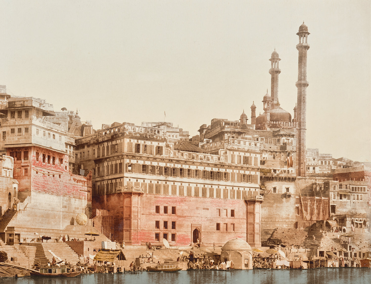 Benares, India 19th C, featuring historic buildings along the riverbank, with intricate architecture and minarets.