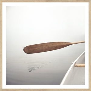 The Paddle wall art depicting a wooden paddle above serene water