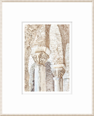 Framed masonry wall art showcasing detailed stone columns in Porec, Croatia.