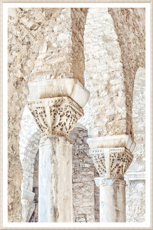 Masonry wall art featuring intricately carved stone columns in Porec, Croatia.