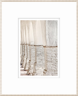 Masonry – Colonnade wall art showcasing white arches and textured columns in a bright view.