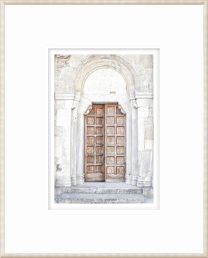 Masonry – Porto, Italy wall art featuring a wooden door with intricate stone archway.
