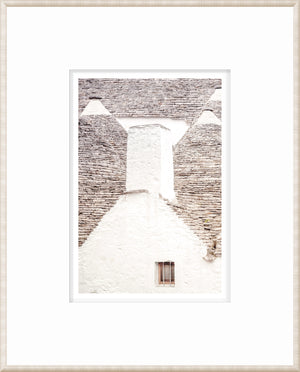 Masonry – Trullo Rooftops wall art showcasing a white stone wall and gray stone roof details.