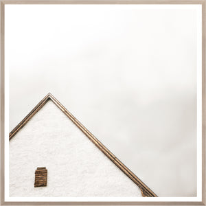 The Peak wall art featuring a minimalist white house roof with wooden accents against a light background.