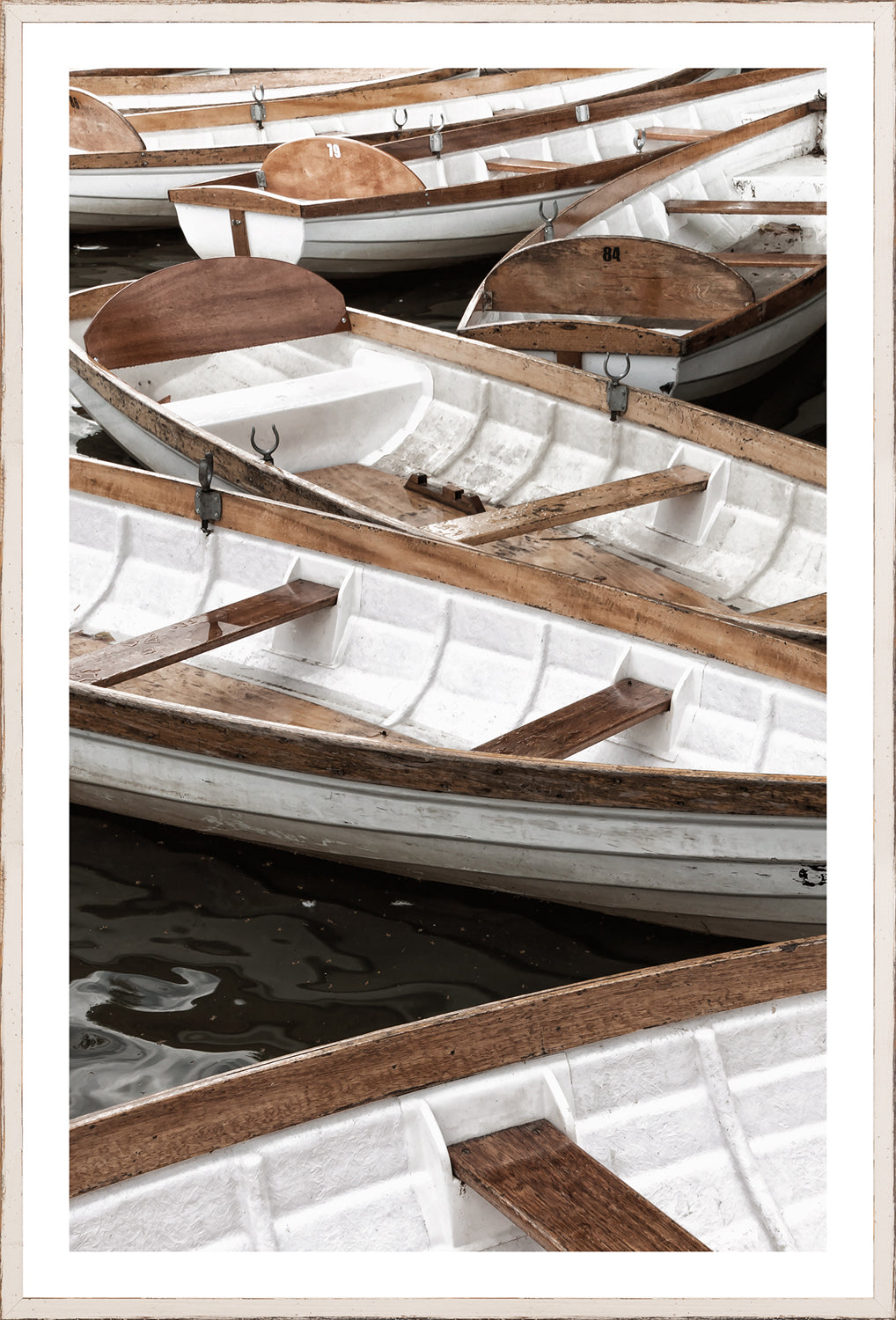 At Mooring II wall art featuring white boats with wooden accents on dark water.