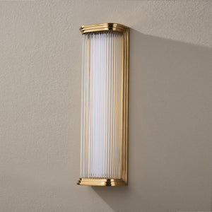 Close-up of the Newburgh Bath And Vanity 5.25" x 17" in aged brass showing the arm spread and shade silhouette.
