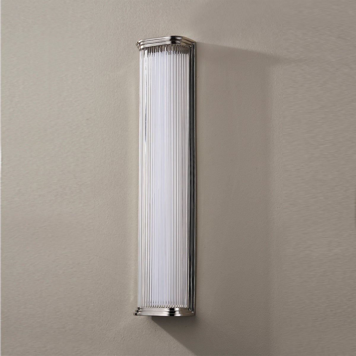 Close-up of the Newburgh Bath And Vanity 5.25" x 24.5" in polished nickel showing the arm spread and shade silhouette.
