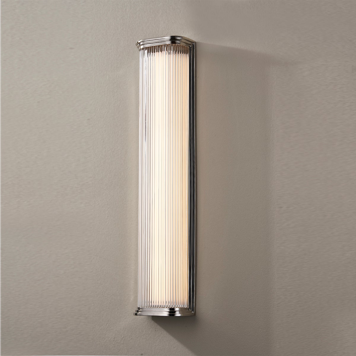 Close-up of the Newburgh Bath And Vanity 5.25" x 24.5" in polished nickel showing the arm spread and shade silhouette.