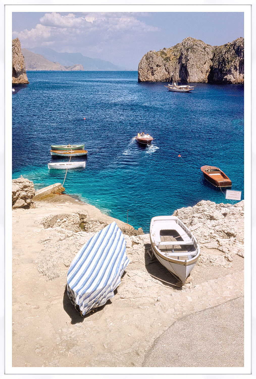 Toni Frissell – Inlet, Capri C. 1959, scenic view of boats in blue water with rocky cliffs